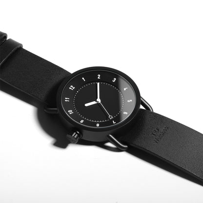 TID No.1 black dial minimalist watch with black leather strap and 9 o’clock crown