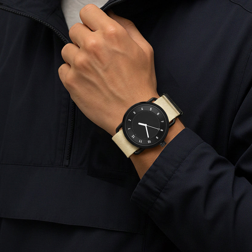 TID No.1 black dial minimalist watch worn with black suit