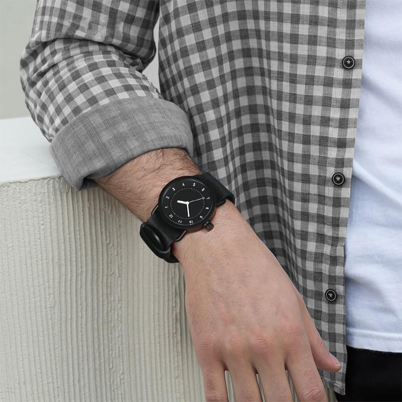 TID No.1 black dial minimalist watch worn with check shirt