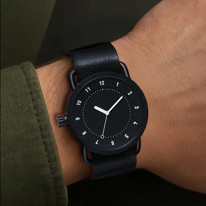 TID No.1 black dial watch worn with dark green sleeve