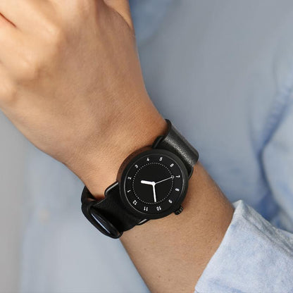 TID No.1 black leather strap watch worn with light blue shirt