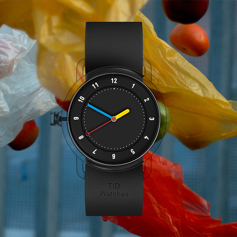 TID No.3 black dial Swedish watch with black silicone strap in colorful lifestyle setting