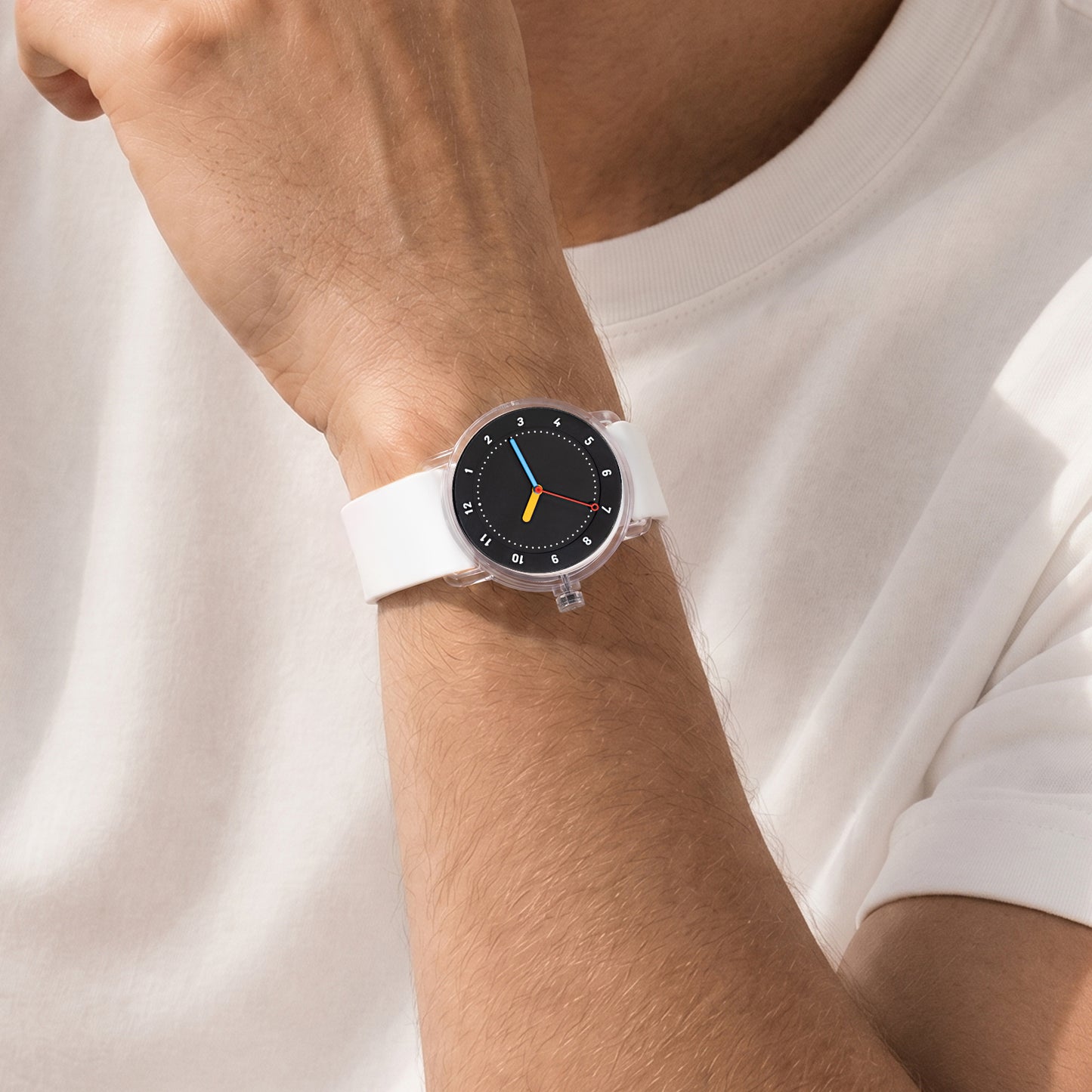 TID No.3 lightweight Swedish watch with white silicone strap and black dial worn with white T-shirt