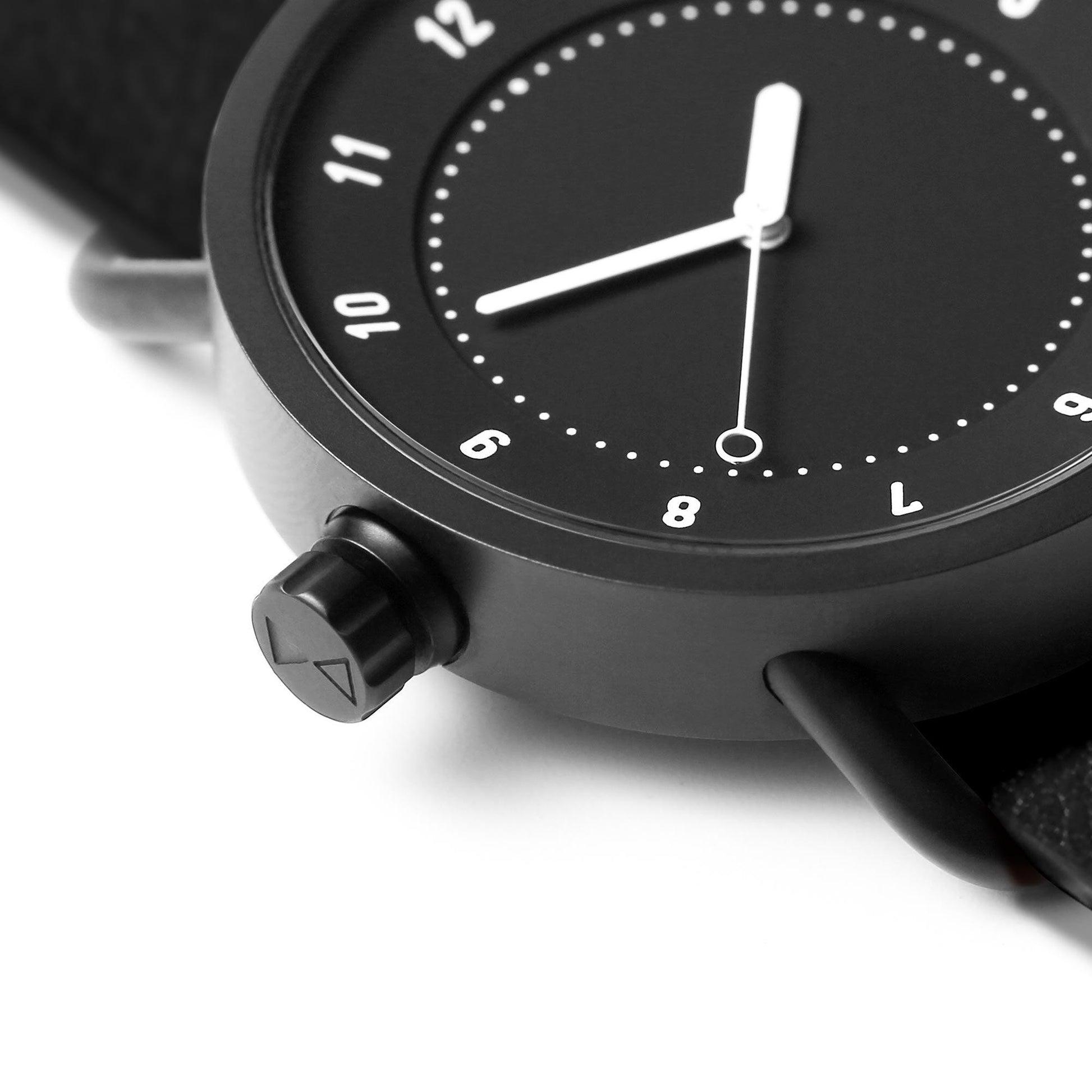Close-up of TID No.1 black dial watch with 9 o’clock crown and case detail