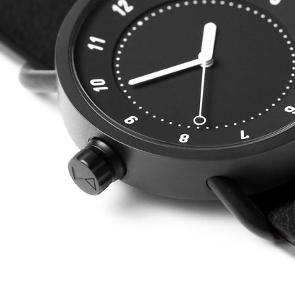 Close-up of TID No.1 black dial watch with 9 o’clock crown and case detail